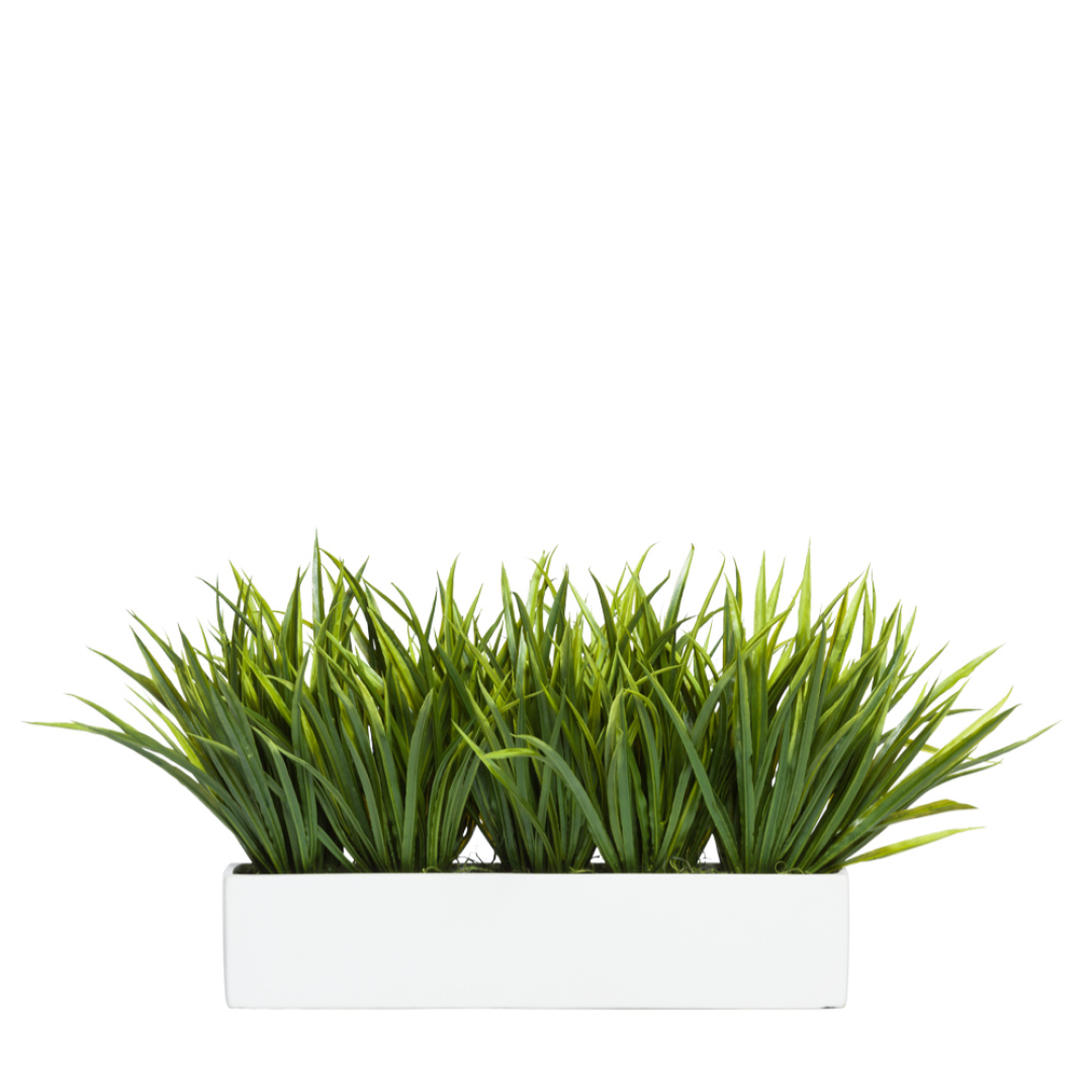 Artificial green grass arrangement in a modern white rectangular planter
