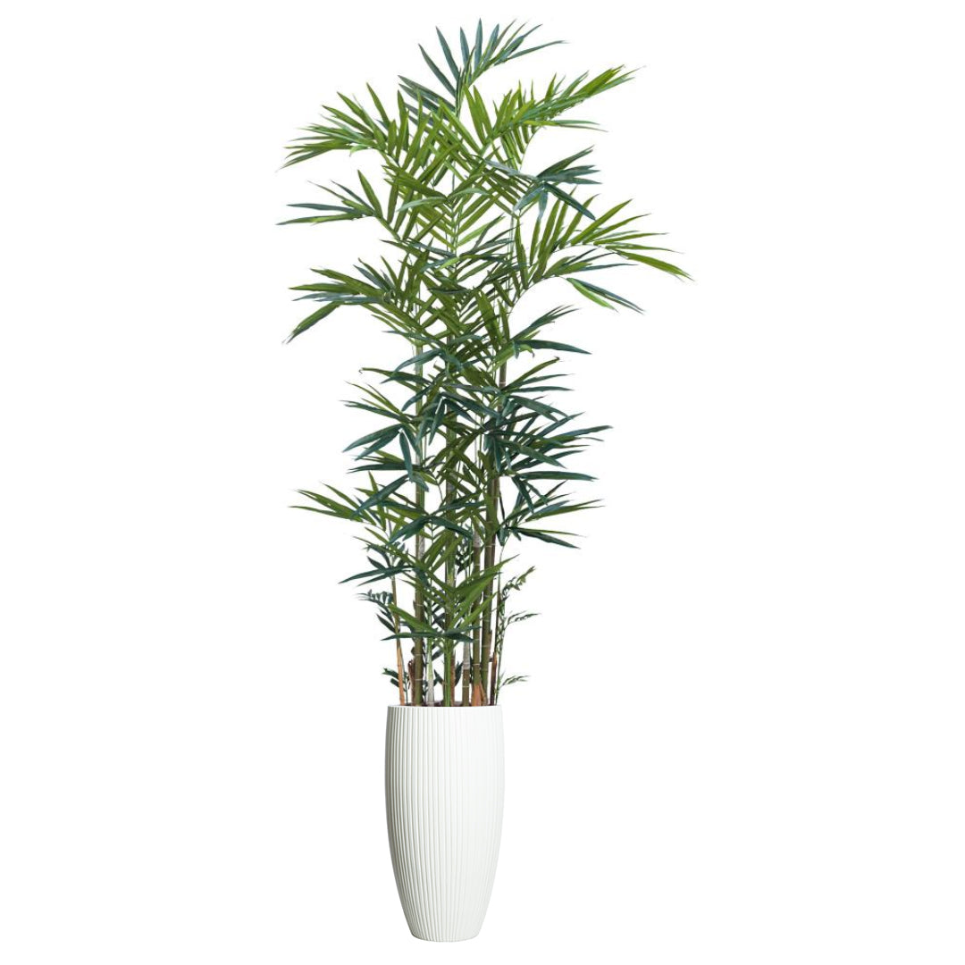 Artificial palm plant with slender green leaves in a tall white ribbed planter