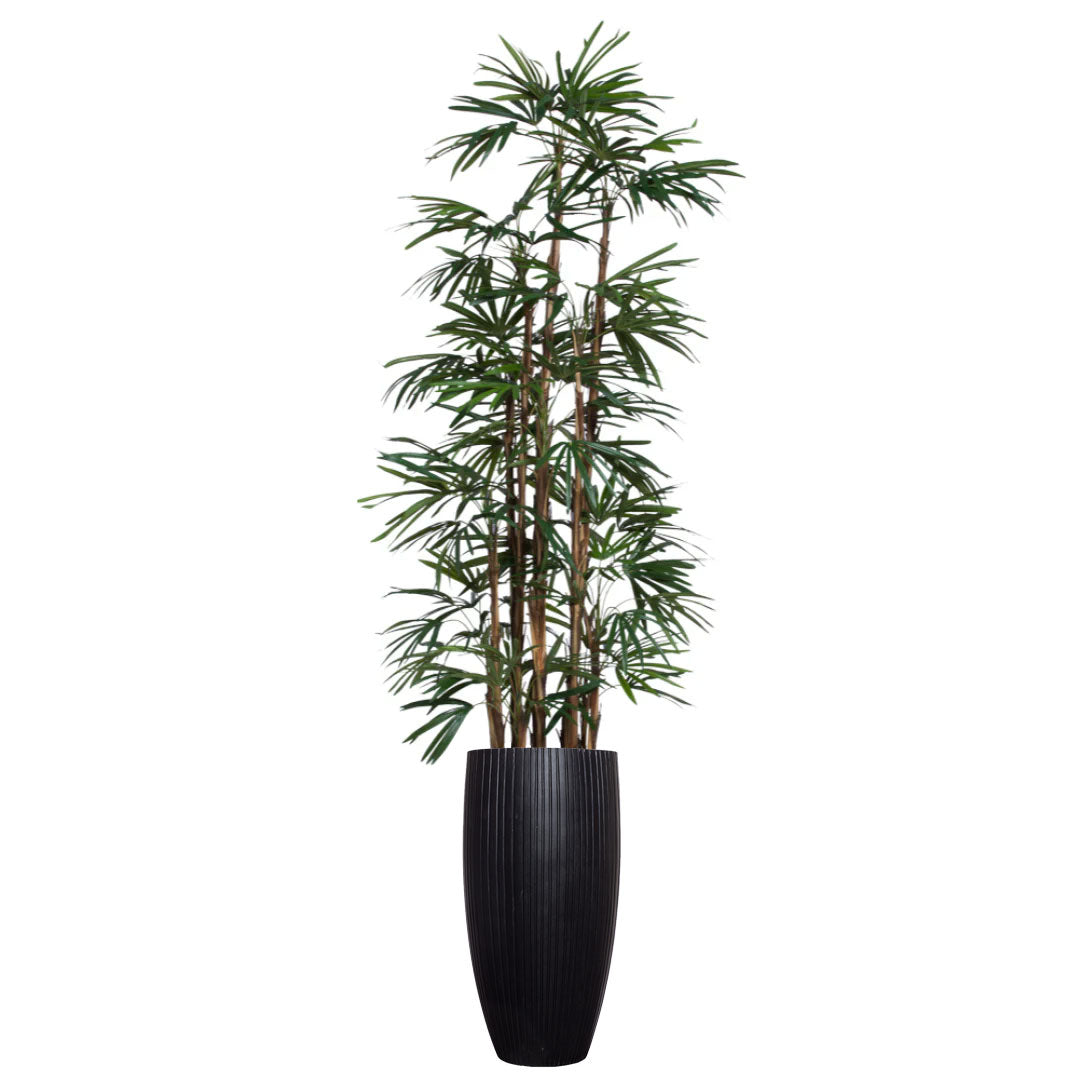 Artificial palm plant with slender green leaves in a tall black ribbed planter