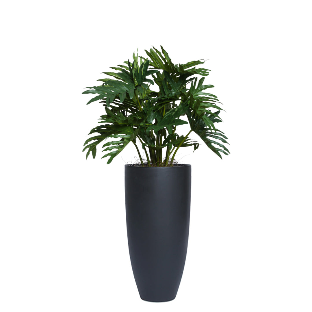 Artificial Philodendron Selloum plant in a tall black planter, lush green split leaves