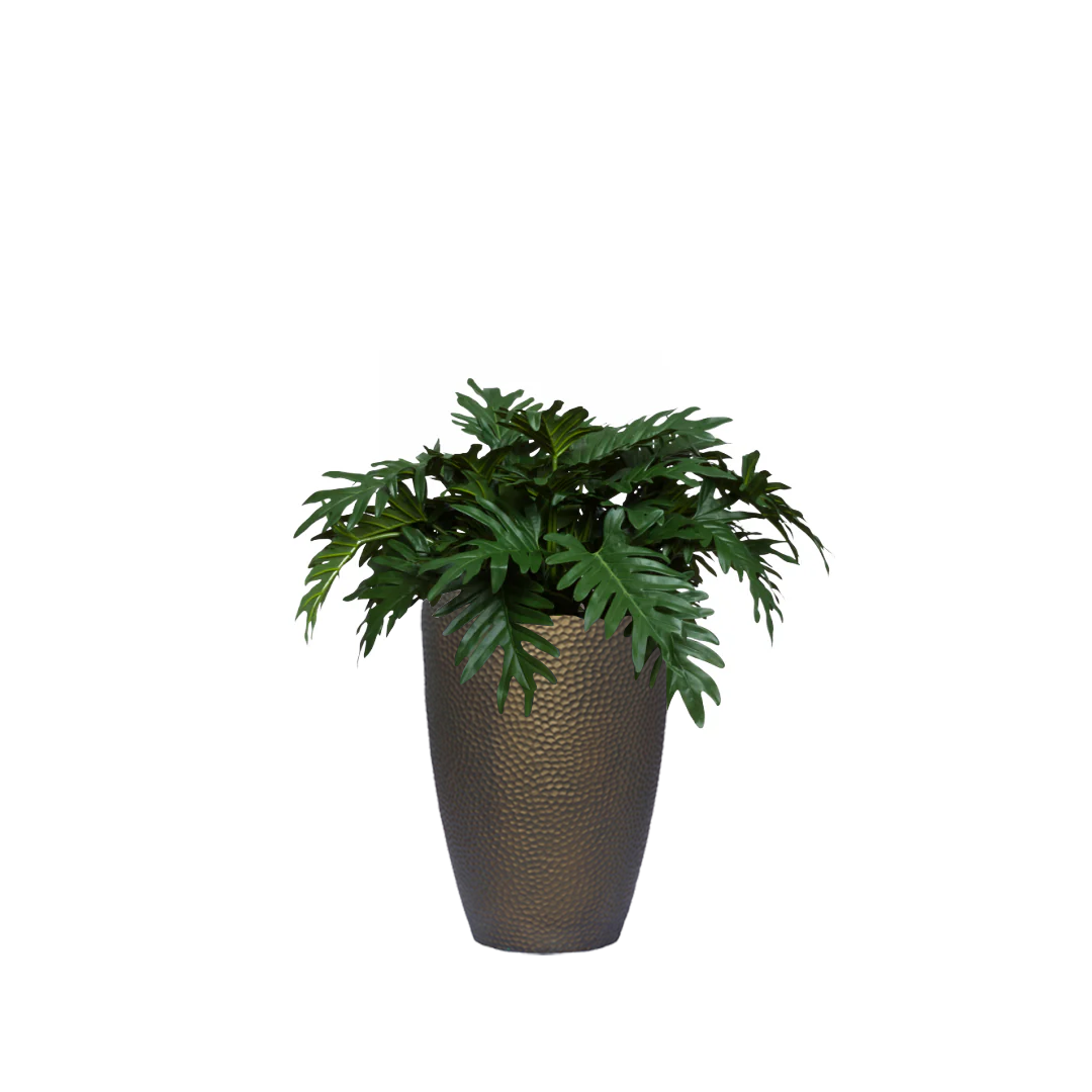 Artificial Philodendron Selloum plant in textured bronze planter against white background