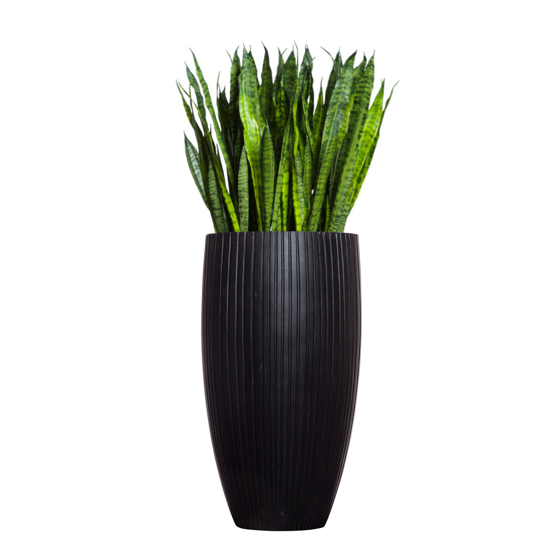 Sansevieria plant in tall ribbed black planter, artificial greenery decor