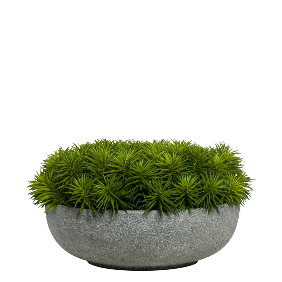 Artificial green succulent arrangement in a round gray stone planter