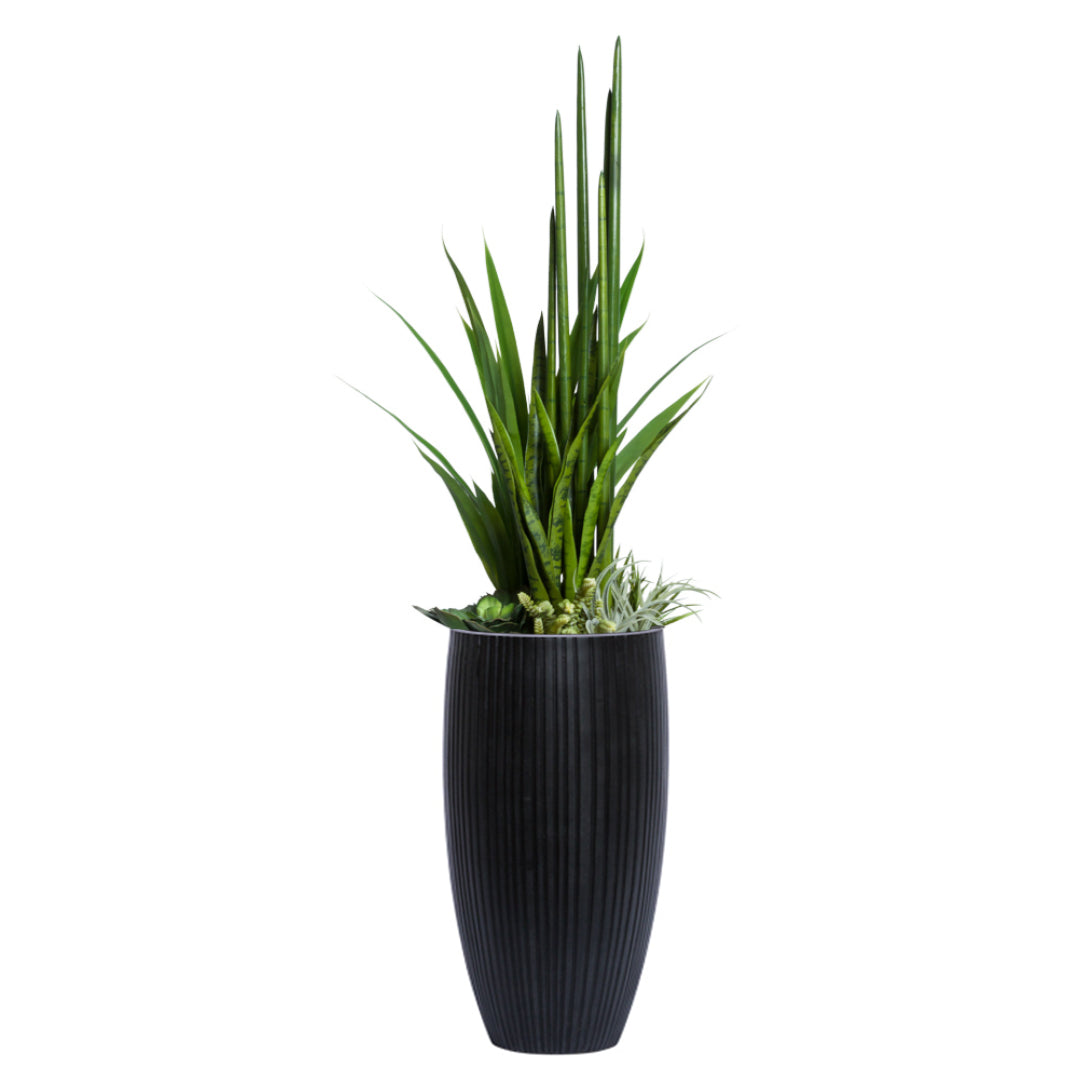 Artificial succulents and greenery arrangement in tall black ribbed planter