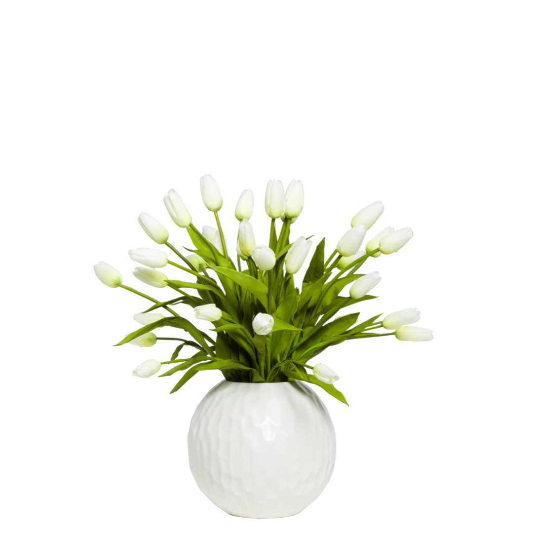 White artificial tulip arrangement in a round textured ceramic vase