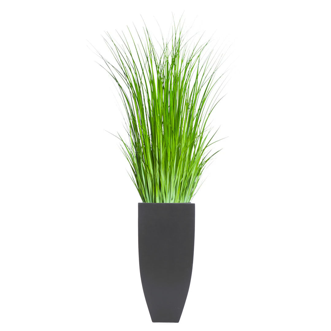 Artificial wild grass in tall matte black planter, modern botanical decor on white background