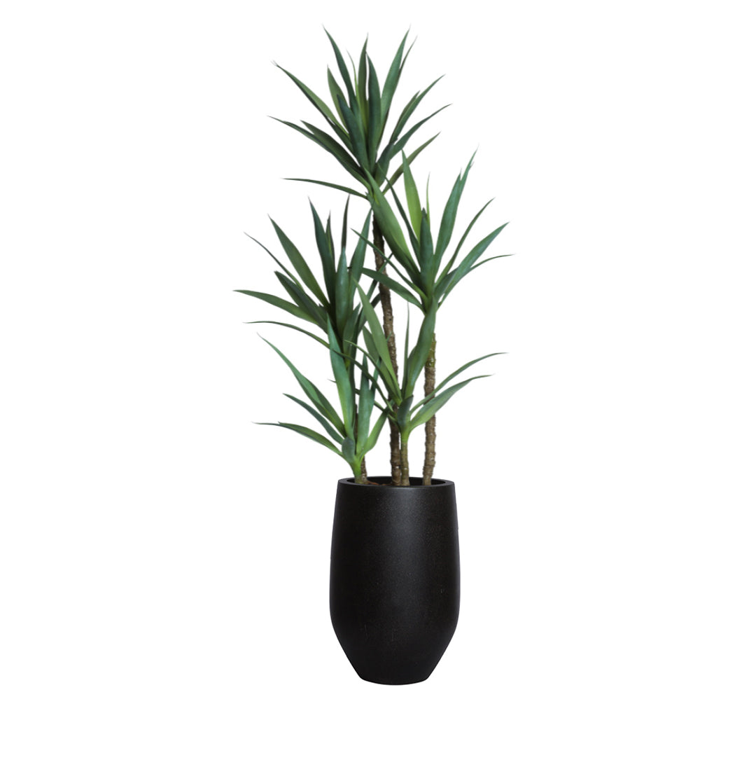 Artificial yucca plant with green leaves in a sleek black planter on white background