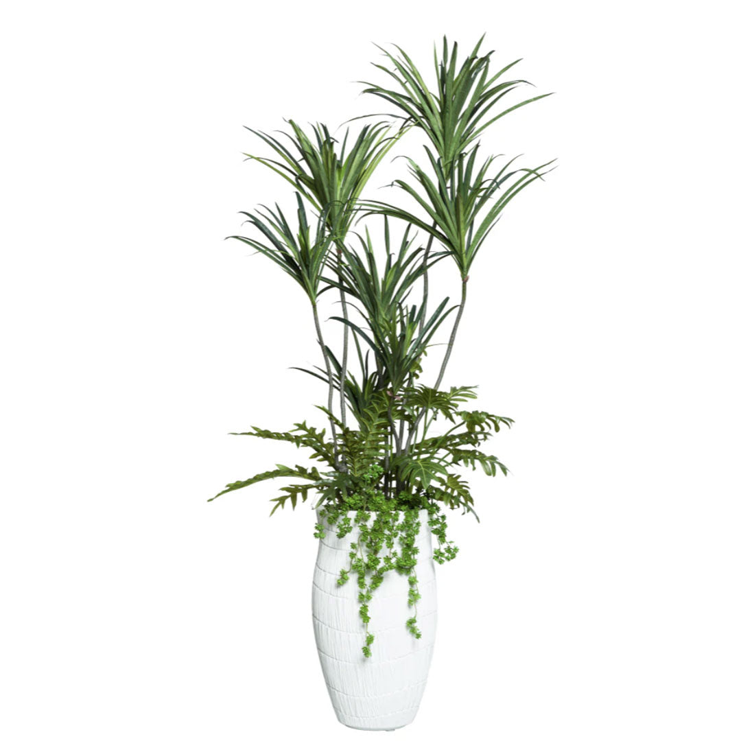 Artificial dracaena plant arrangement with fern and trailing greenery in a white textured vase